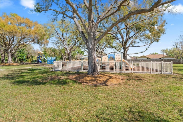 view of yard featuring fence and a playground