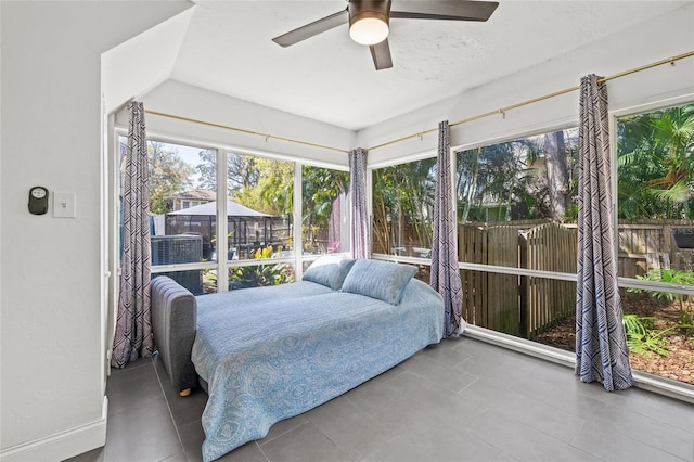 bedroom with a ceiling fan and multiple windows