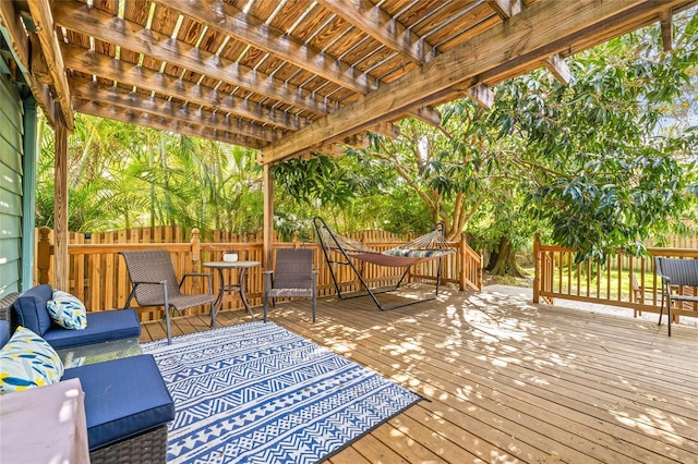 wooden terrace featuring a pergola, fence, and an outdoor hangout area