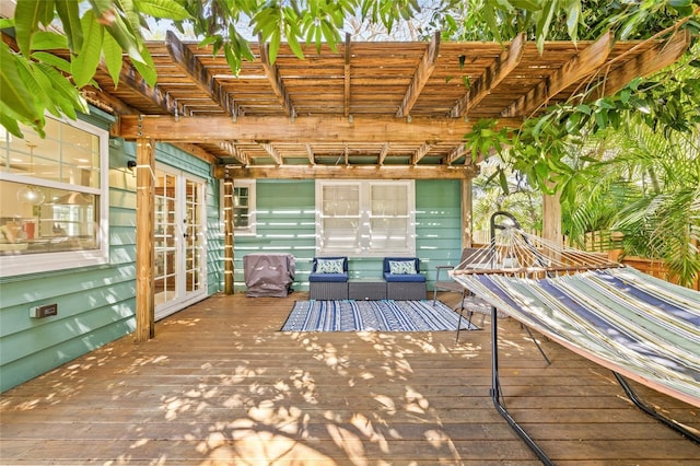 wooden terrace with french doors, outdoor lounge area, and a pergola