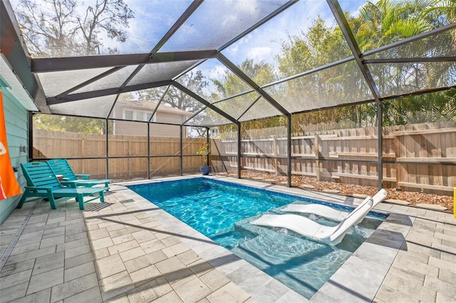 view of pool featuring a patio area, a fenced backyard, and a lanai