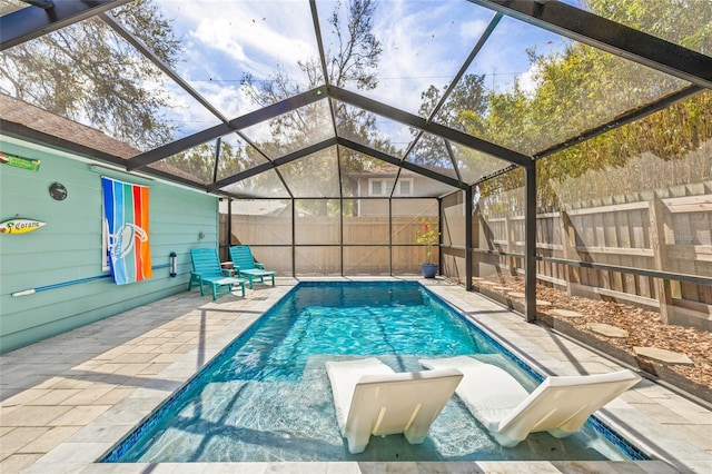 view of swimming pool featuring a fenced in pool, a fenced backyard, a lanai, a water slide, and a patio area