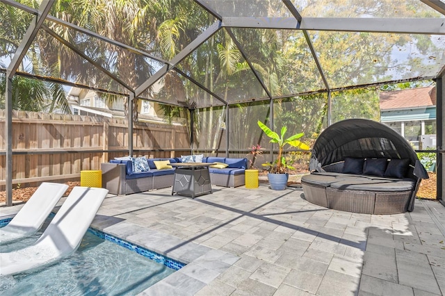 view of patio featuring fence, an outdoor living space, and a lanai