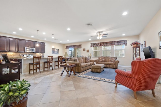 living room featuring light tile patterned flooring, recessed lighting, a ceiling fan, baseboards, and visible vents