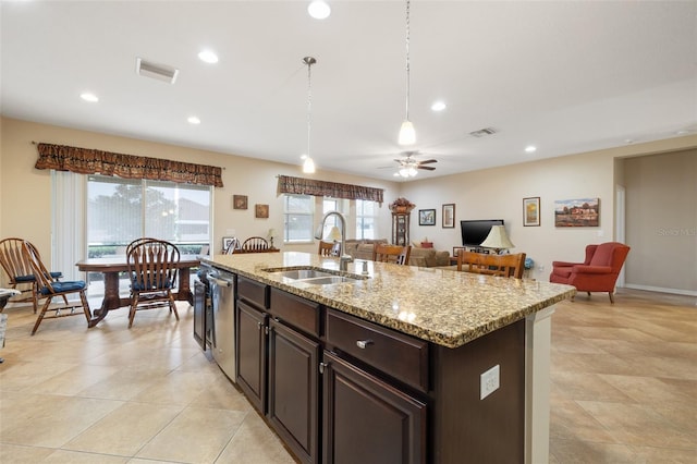 kitchen featuring visible vents, a sink, an island with sink, and stainless steel dishwasher