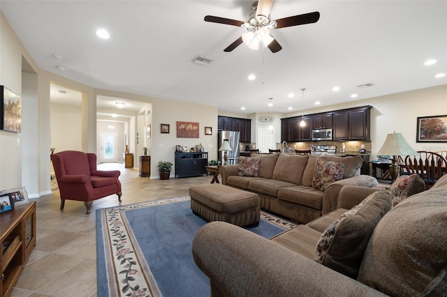 living room featuring visible vents, baseboards, ceiling fan, recessed lighting, and light tile patterned floors