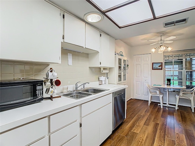 kitchen featuring visible vents, white cabinets, a sink, black microwave, and dishwasher