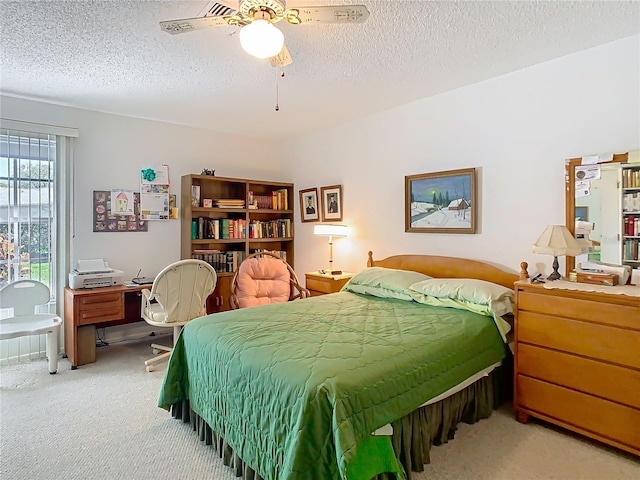 bedroom with carpet floors, a textured ceiling, and a ceiling fan