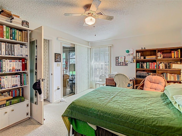 bedroom with a textured ceiling, access to outside, light carpet, and a ceiling fan