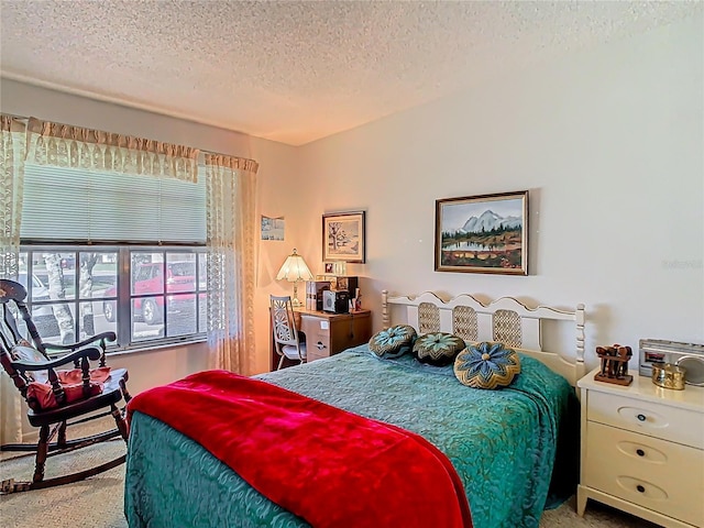 bedroom featuring a textured ceiling and carpet