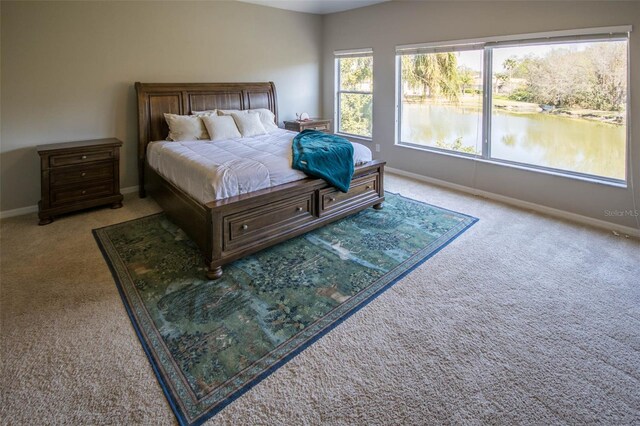 bedroom featuring carpet floors and baseboards