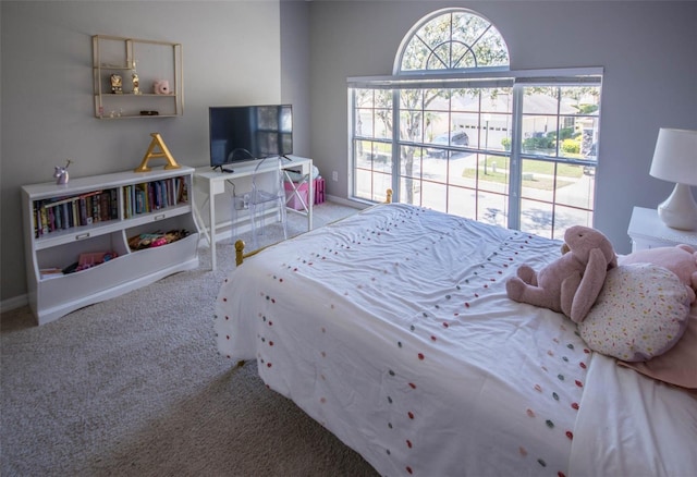 carpeted bedroom featuring baseboards