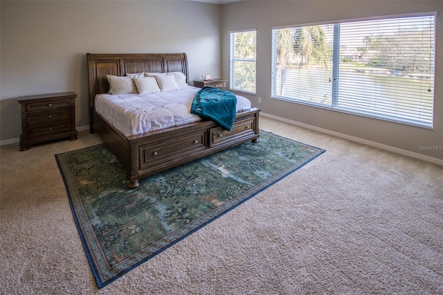 bedroom with carpet flooring and baseboards