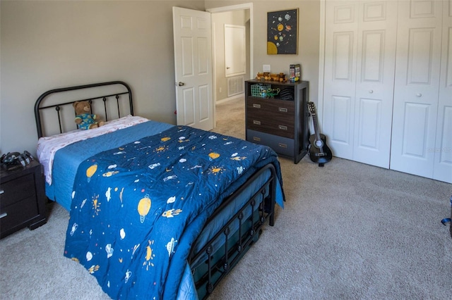 bedroom with a closet, carpet flooring, and visible vents