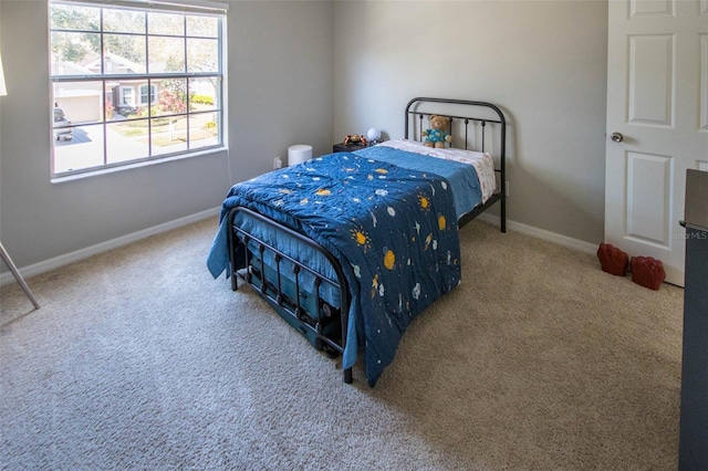 bedroom featuring carpet floors and baseboards