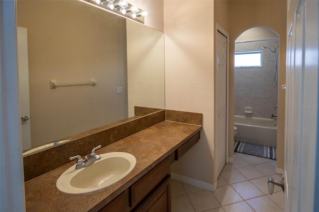 full bath featuring tile patterned flooring, toilet, shower / bath combination, vanity, and baseboards