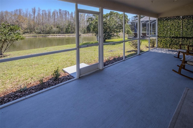 unfurnished sunroom with a wealth of natural light and a water view