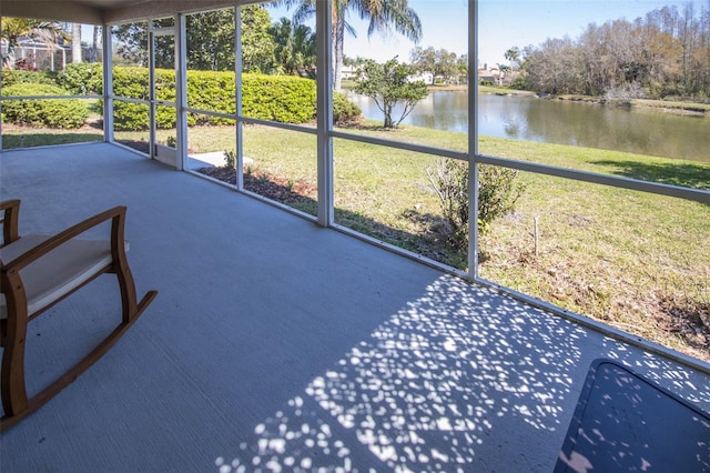 unfurnished sunroom with a water view