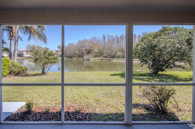 unfurnished sunroom featuring a water view