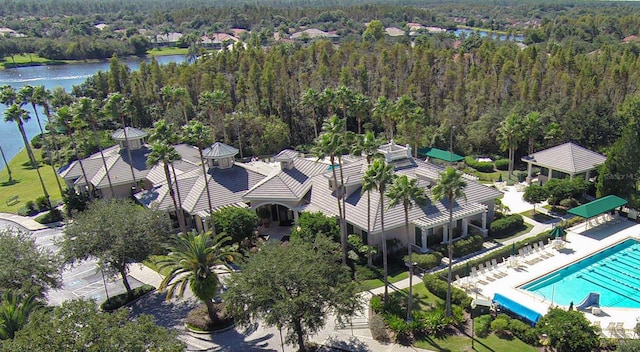 aerial view with a water view and a forest view