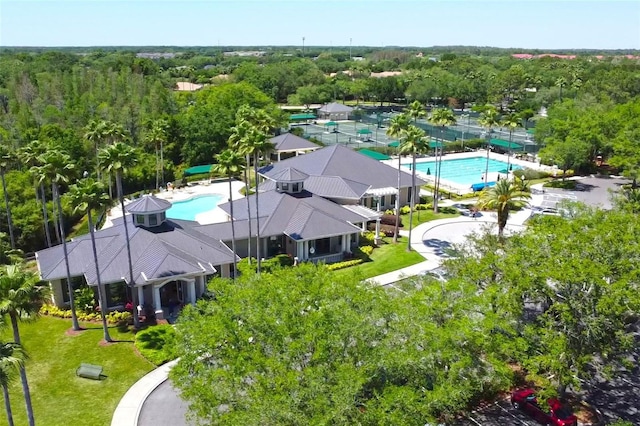 drone / aerial view with a wooded view