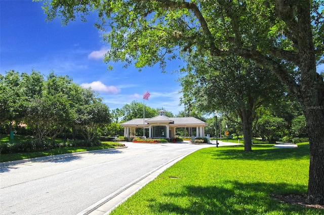 view of front of home with concrete driveway and a front lawn