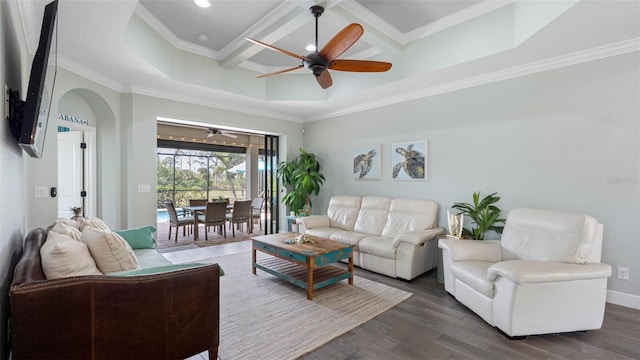 living area featuring baseboards, coffered ceiling, ceiling fan, ornamental molding, and dark wood-type flooring