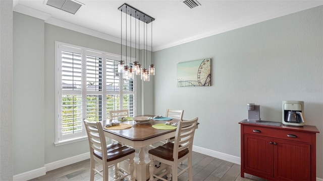 135 Cabana Way, Rotonda West, FL 33947 - dining area featuring crown molding, light wood-style floors, and baseboards