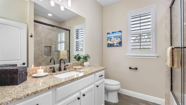 135 Cabana Way, Rotonda West, FL 33947 - full bathroom featuring plenty of natural light, a shower stall, vanity, and toilet