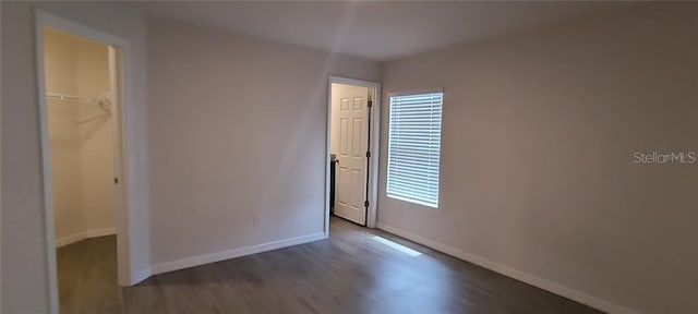 empty room with wood finished floors and baseboards