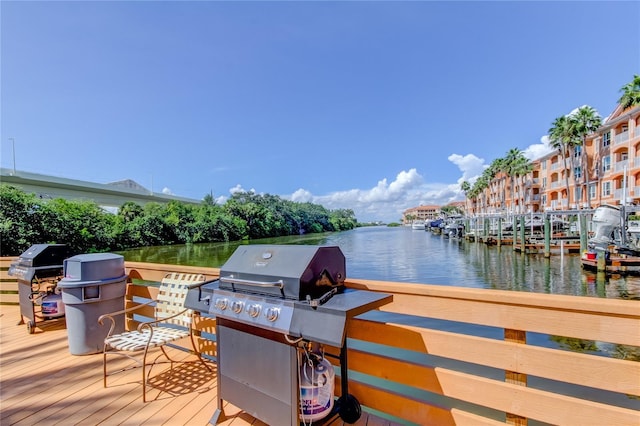 deck with a water view and grilling area