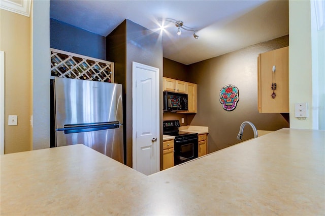 kitchen featuring a sink, light countertops, black appliances, light brown cabinets, and track lighting