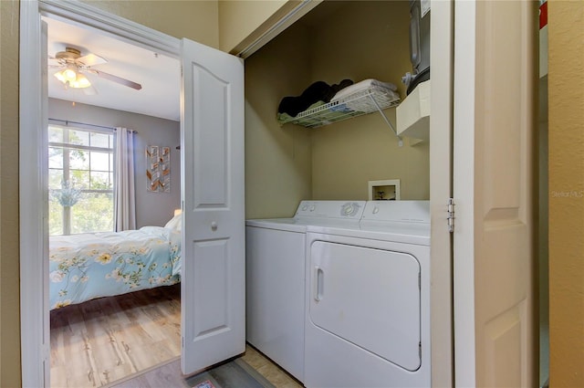 laundry area featuring washing machine and dryer, laundry area, ceiling fan, and light wood-style flooring