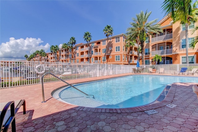 pool featuring fence and a patio