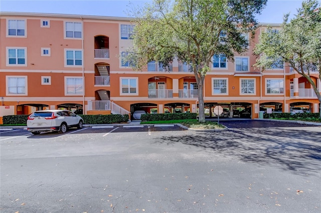 view of property featuring uncovered parking