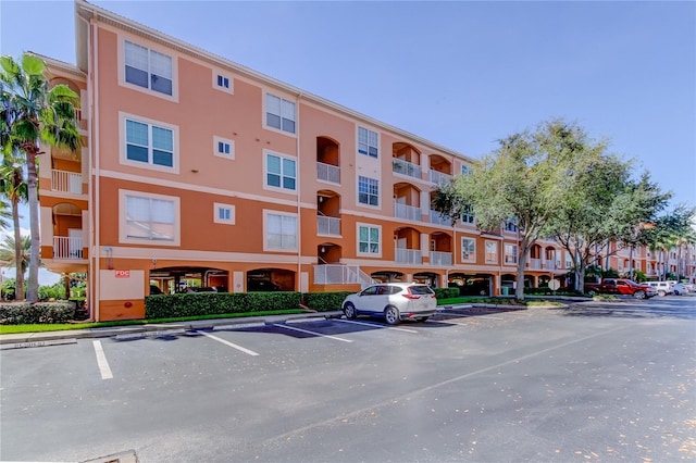 view of building exterior with uncovered parking