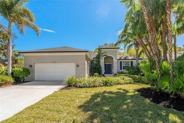 mediterranean / spanish-style home with a garage, driveway, a front lawn, and stucco siding