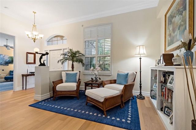 sitting room featuring ornamental molding, wood finished floors, and baseboards