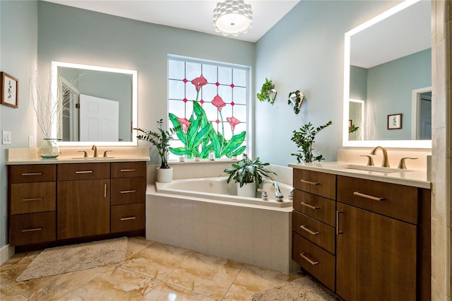 full bathroom featuring two vanities, a sink, and a bath