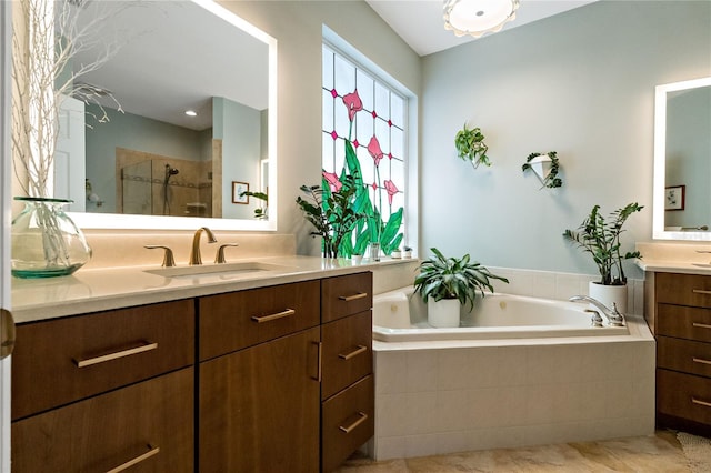 bathroom with two vanities, a sink, a bath, and a shower stall