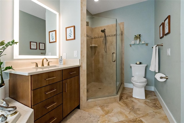 full bathroom with a stall shower, baseboards, vanity, and toilet