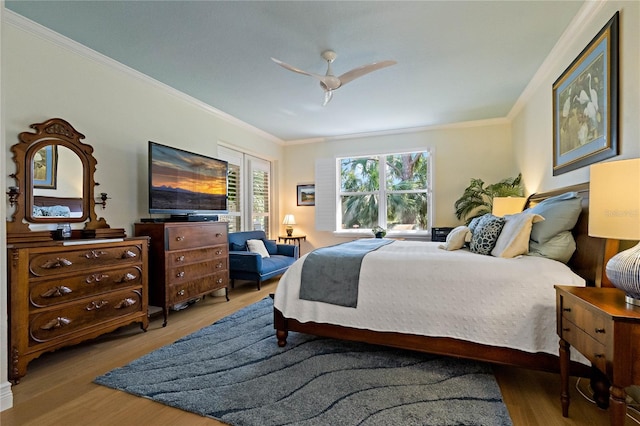 bedroom featuring crown molding, ceiling fan, and wood finished floors