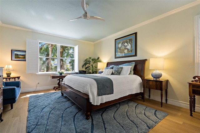 bedroom with crown molding, baseboards, and wood finished floors