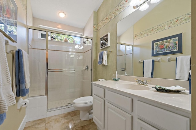 bathroom featuring a stall shower, vanity, toilet, and tile patterned floors