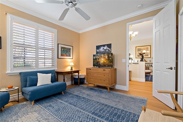 living area with a ceiling fan, baseboards, crown molding, and wood finished floors