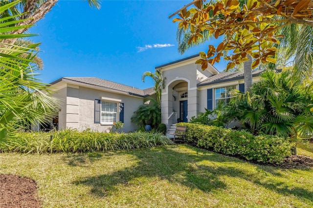 mediterranean / spanish-style house with a front yard and stucco siding