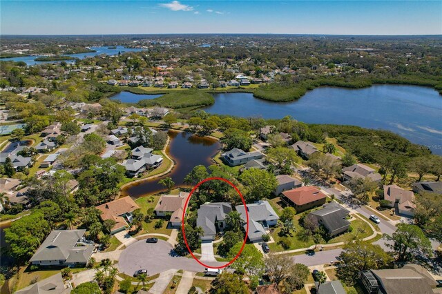 birds eye view of property with a water view and a residential view