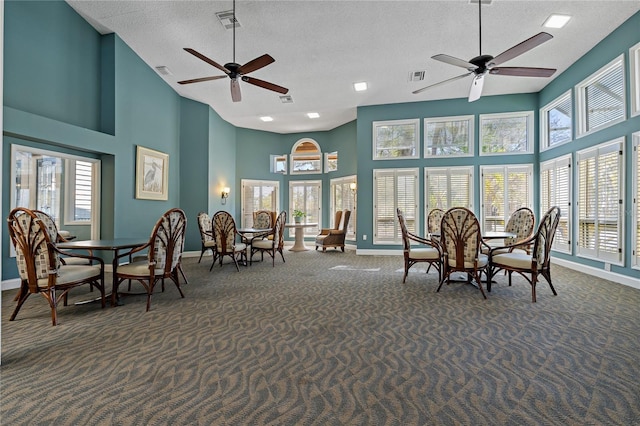 interior space featuring plenty of natural light, dark carpet, and visible vents