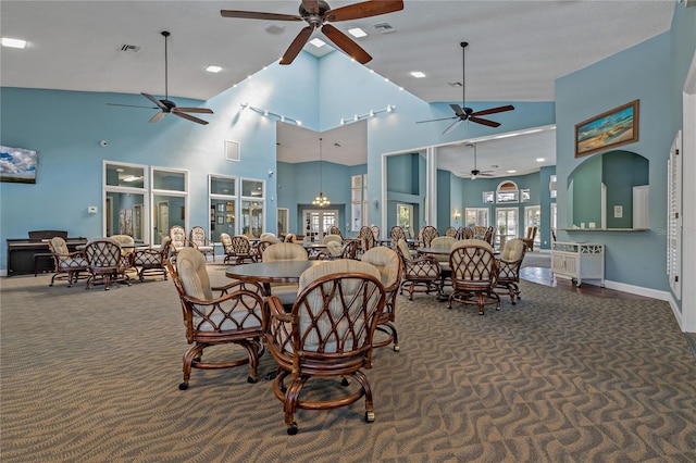 dining room with lofted ceiling, carpet floors, visible vents, and baseboards