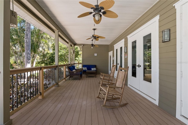 wooden terrace with ceiling fan, french doors, and an outdoor hangout area